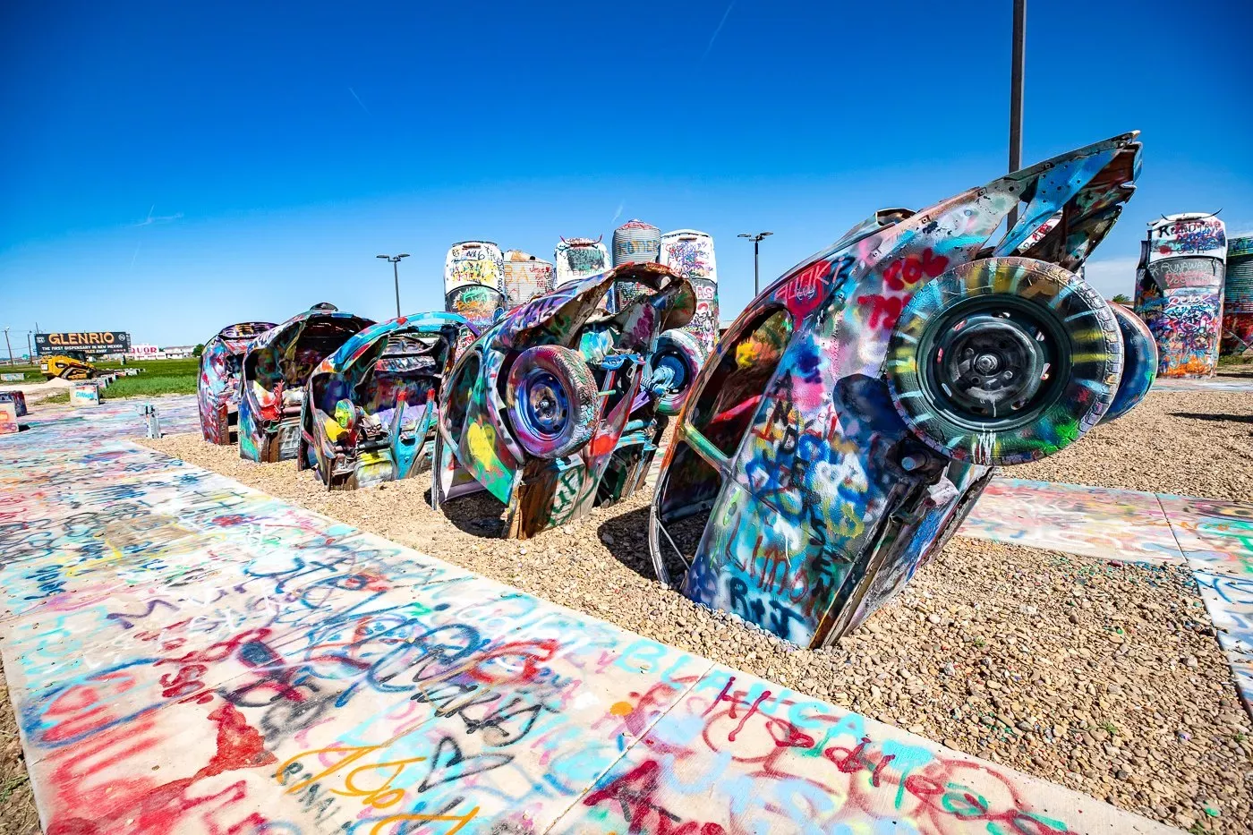 Slug bugs half buried in the ground for people to spray paint.